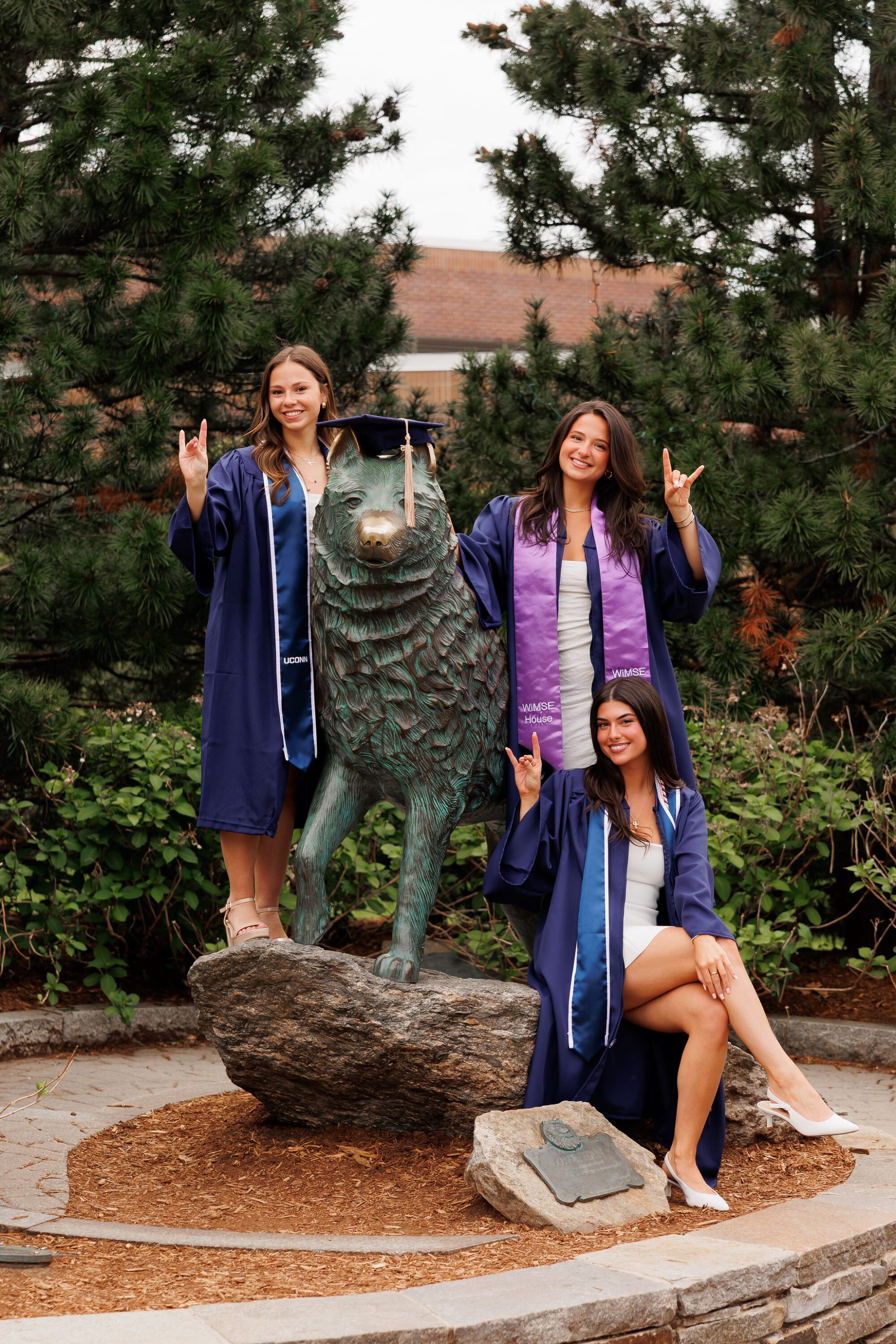 uconn grad photos with husky statue

